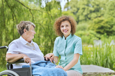 elder woman smiling with her caregiver